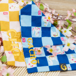 Zwei TsukiAshi Halstücher fürs Halsband. Einmal im japanischen Stoff in blau mit kleinen Schlangen und der Bestickung Gacho und einmal in Gelb mit kleinen Schlangen mit der Bestickun Cho